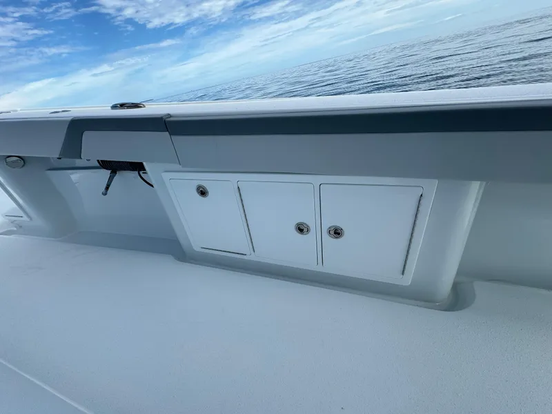 Slide: The Image of 2024 Yellowfin 39 boat deck with storage compartments, ocean view in the background. - 37