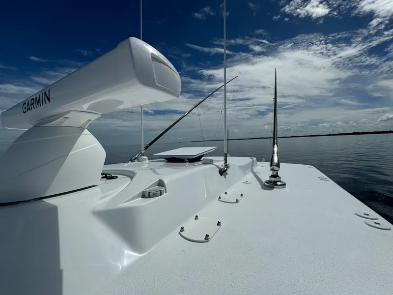 Slide: The Image of 2024 Yellowfin 39 boat deck with Garmin radar under a clear sky. - 38