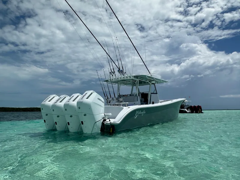 Slide: The Image of 2024 Yellowfin 39 boat with four outboard motors in clear turquoise water. - 4