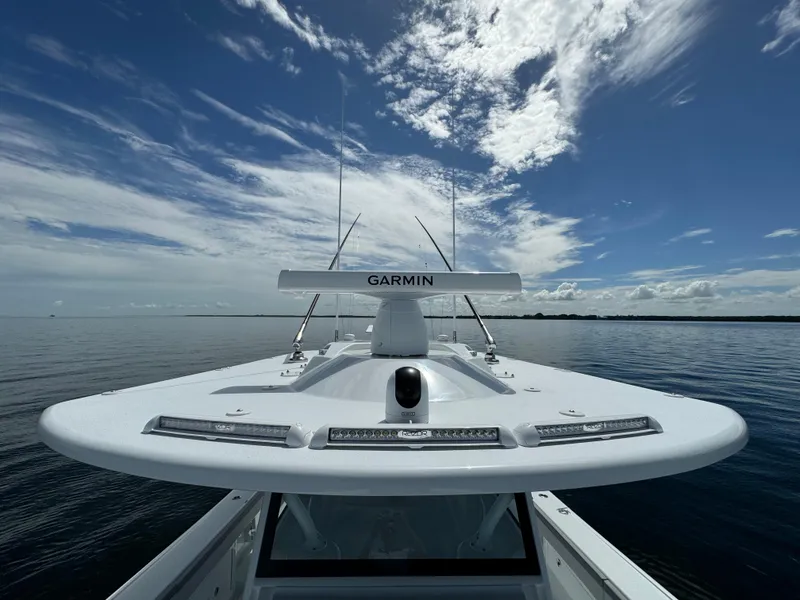 Slide: The Image of 2024 Yellowfin 39 boat with Garmin radar on calm waters under a partly cloudy sky. - 40