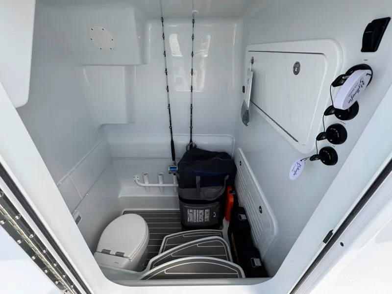 Slide: The Image of Interior of 2024 Yellowfin 39 boat with storage, toilet, and fishing rods. - 41