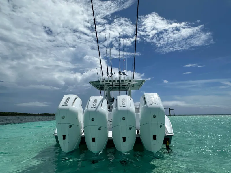 Slide: The Image of 2024 Yellowfin 39 boat with four powerful outboard engines on clear turquoise water. - 5