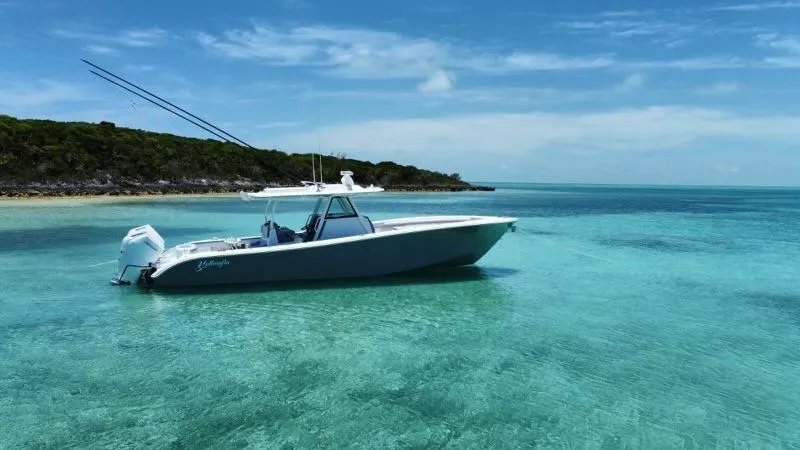 Slide: The Image of 2024 Yellowfin 39 boat in clear turquoise water near a tropical island. - 7
