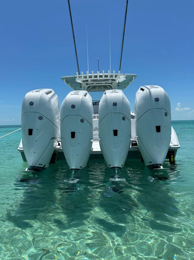 Slide: The Image of 2024 Yellowfin 39 boat with four powerful outboard engines in clear blue water. - 9