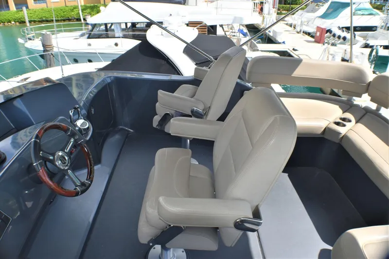 Slide: The Image of Flybridge seating area of 2019 Silverton 41 Sport Bridge yacht, featuring dual captain's chairs. - 12
