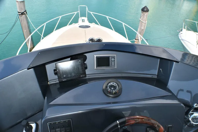 Slide: The Image of 2019 Silverton 41 Sport Bridge helm with navigation equipment and compass. - 15