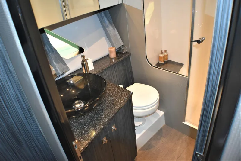 Slide: The Image of 2019 Silverton 41 Sport Bridge bathroom with modern sink, toilet, and shower. - 23