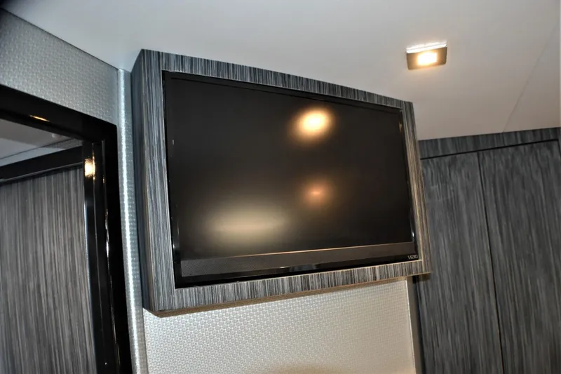 Slide: The Image of Wall-mounted TV in the interior of a 2019 Silverton 41 Sport Bridge yacht. - 24