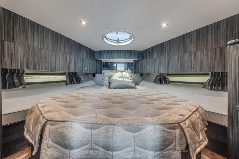 Slide: The Image of Luxurious bedroom interior of 2019 Silverton 41 Sport Bridge yacht with circular skylight. - 25
