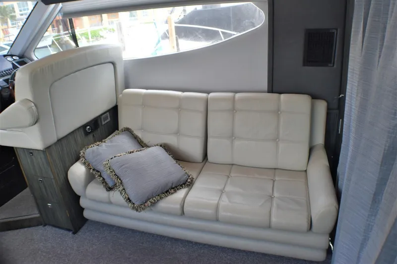 Slide: The Image of Luxurious interior of 2019 Silverton 41 Sport Bridge with leather seating and decorative pillows. - 34