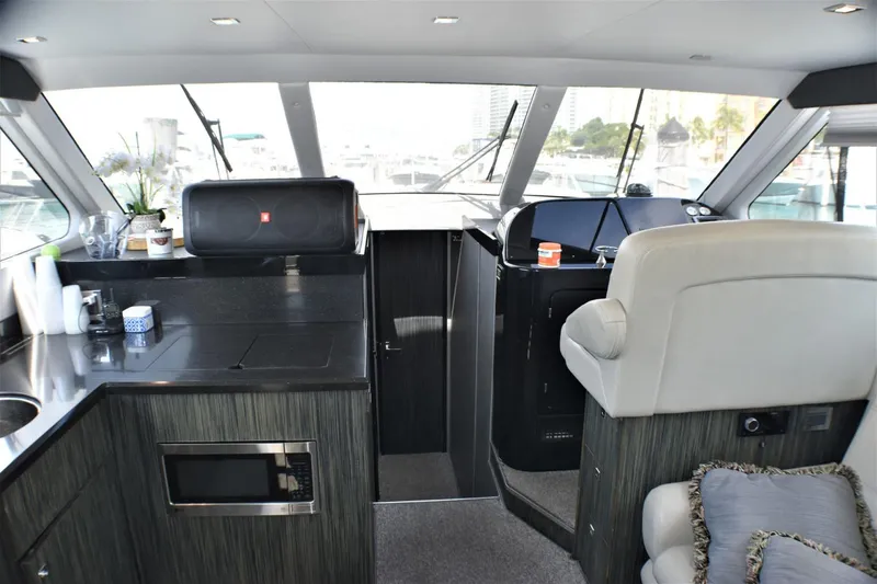 Slide: The Image of Interior of 2019 Silverton 41 Sport Bridge yacht with modern kitchen and helm station. - 35