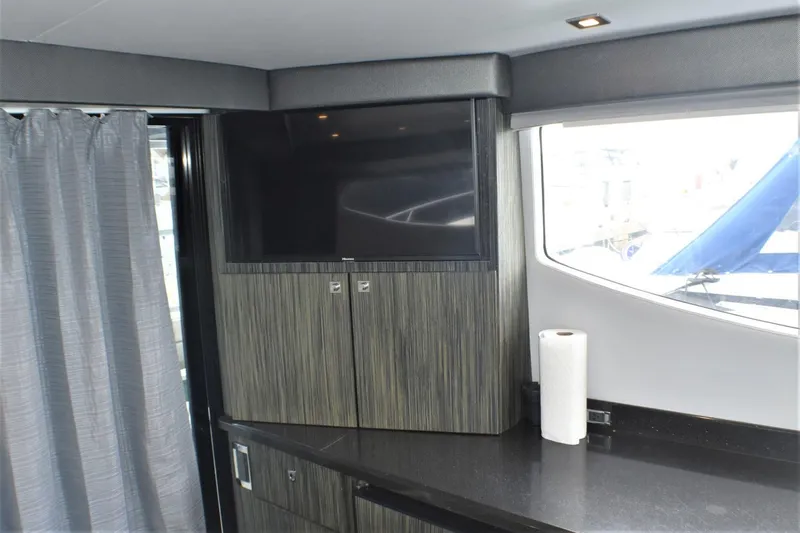 Slide: The Image of Interior of 2019 Silverton 41 Sport Bridge with TV and countertop. - 45