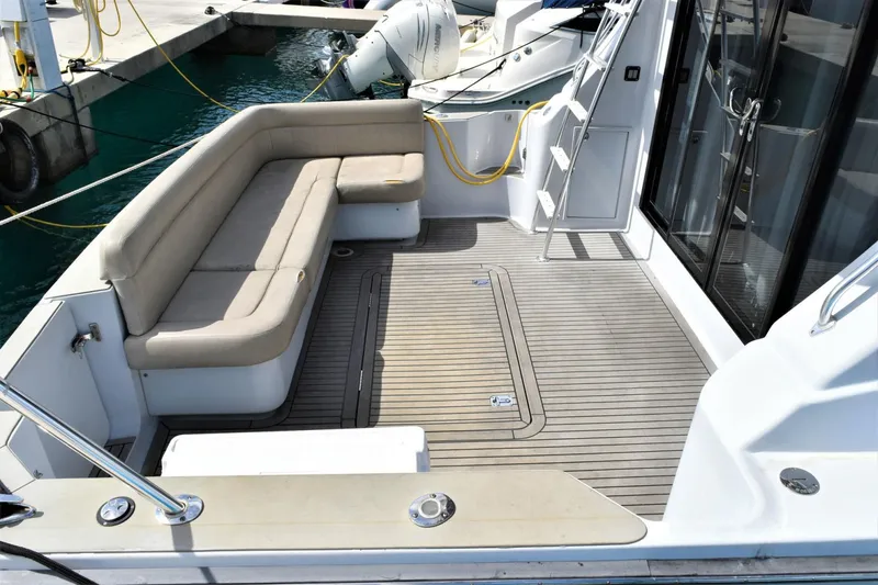 Slide: The Image of 2019 Silverton 41 Sport Bridge boat with spacious deck and comfortable seating. - 7