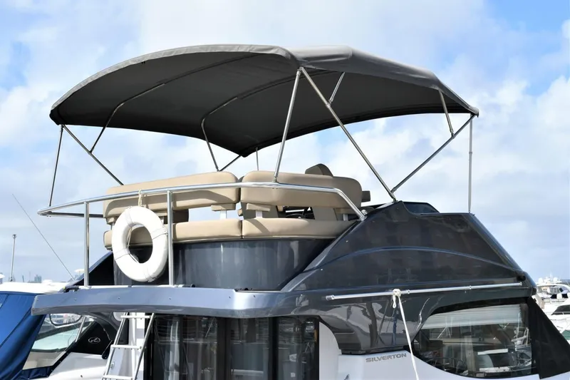 Slide: The Image of 2019 Silverton 41 Sport Bridge yacht with upper deck and canopy. - 8