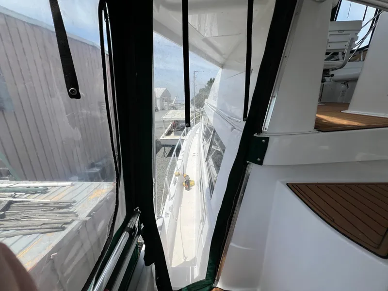 Slide: The Image of View from the deck of a 1998 Mainship 47 Motor Yacht, showing enclosed walkway. - 14