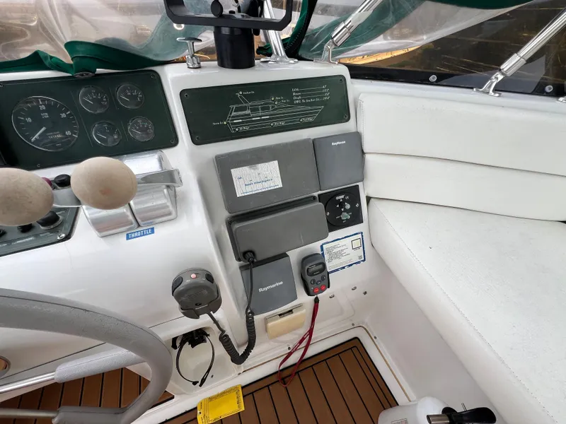 Slide: The Image of 1998 Mainship 47 Motor Yacht helm with gauges, controls, and navigation equipment. - 22