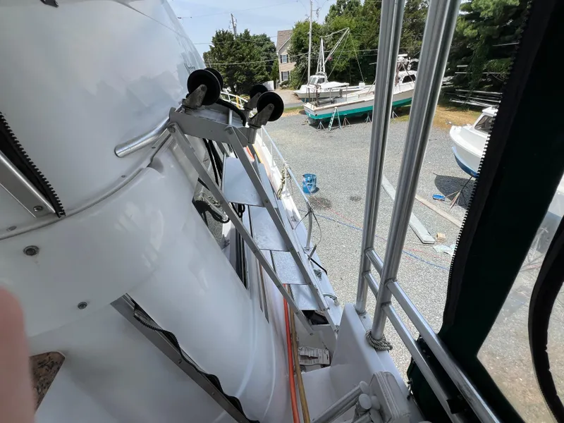 Slide: The Image of 1998 Mainship 47 Motor Yacht on dry dock, showing deck and surrounding boats. - 27