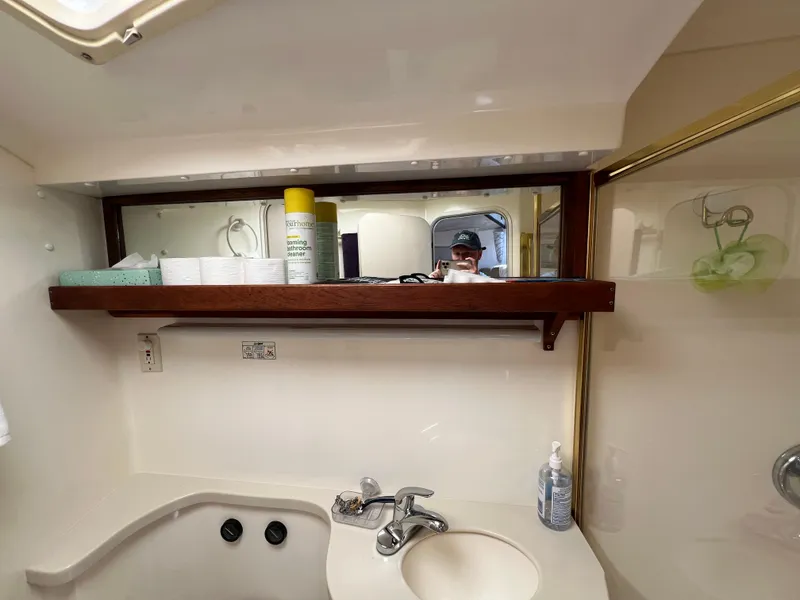 Slide: The Image of Bathroom interior of 1998 Mainship 47 Motor Yacht with sink and toiletries. - 39