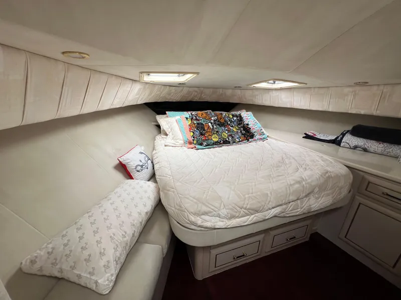 Slide: The Image of Cozy bedroom interior of 1998 Mainship 47 Motor Yacht with plush bedding and decorative pillows. - 42