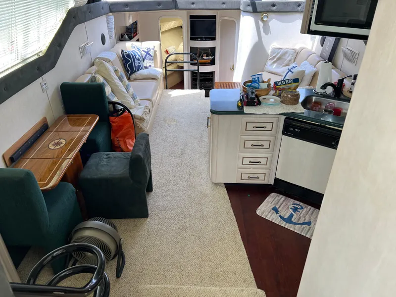 Slide: The Image of Interior of a 1998 Mainship 47 Motor Yacht with cozy seating and kitchen area. - 45