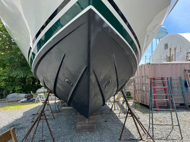 Slide: The Image of 1998 Mainship 47 Motor Yacht on dry dock, showing hull and support stands. - 6