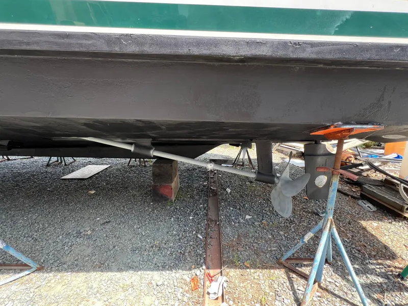 Slide: The Image of 1998 Mainship 47 Motor Yacht underbody with propeller and support stands. - 7