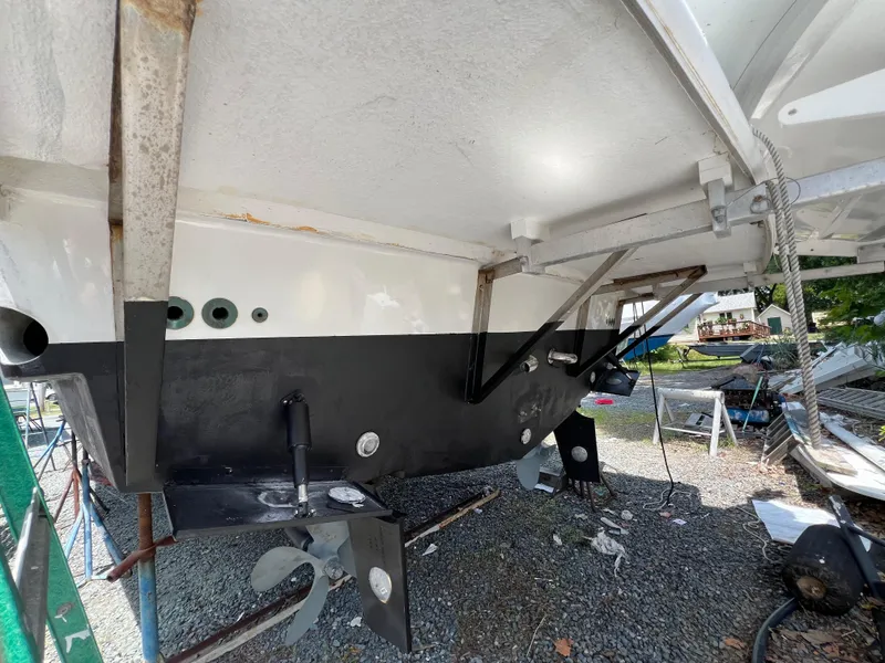 Slide: The Image of 1998 Mainship 47 Motor Yacht under maintenance, showing hull and propeller details. - 9