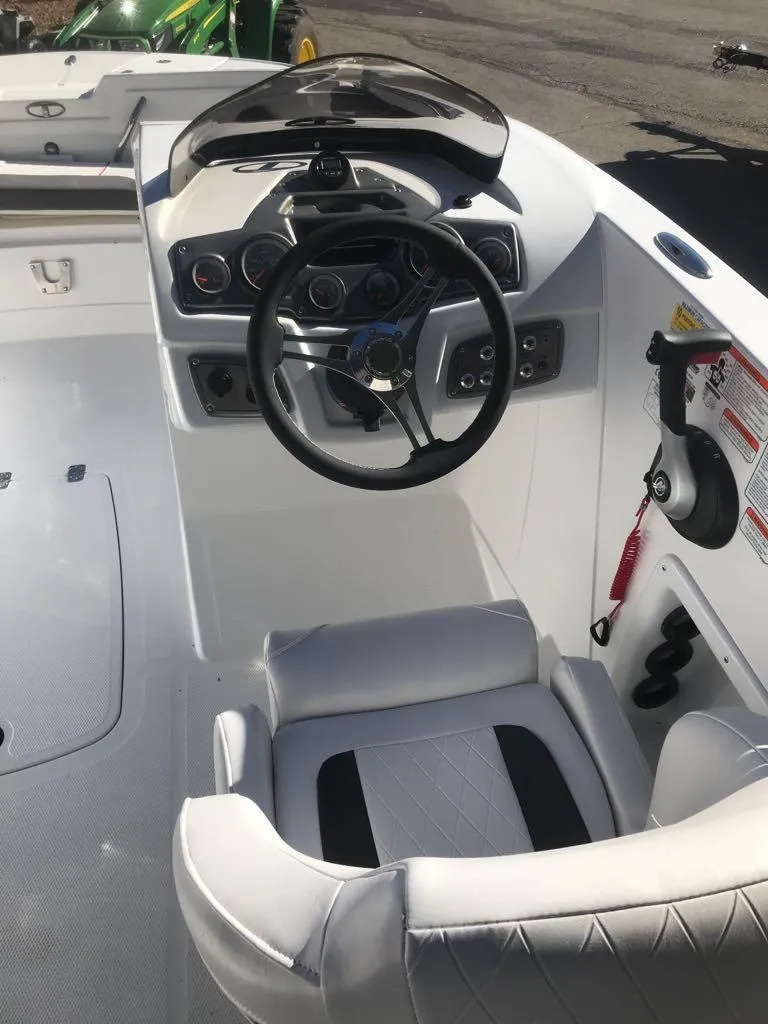 Slide: The Image of 2024 Tahoe 1950 boat cockpit with steering wheel and controls. - 10