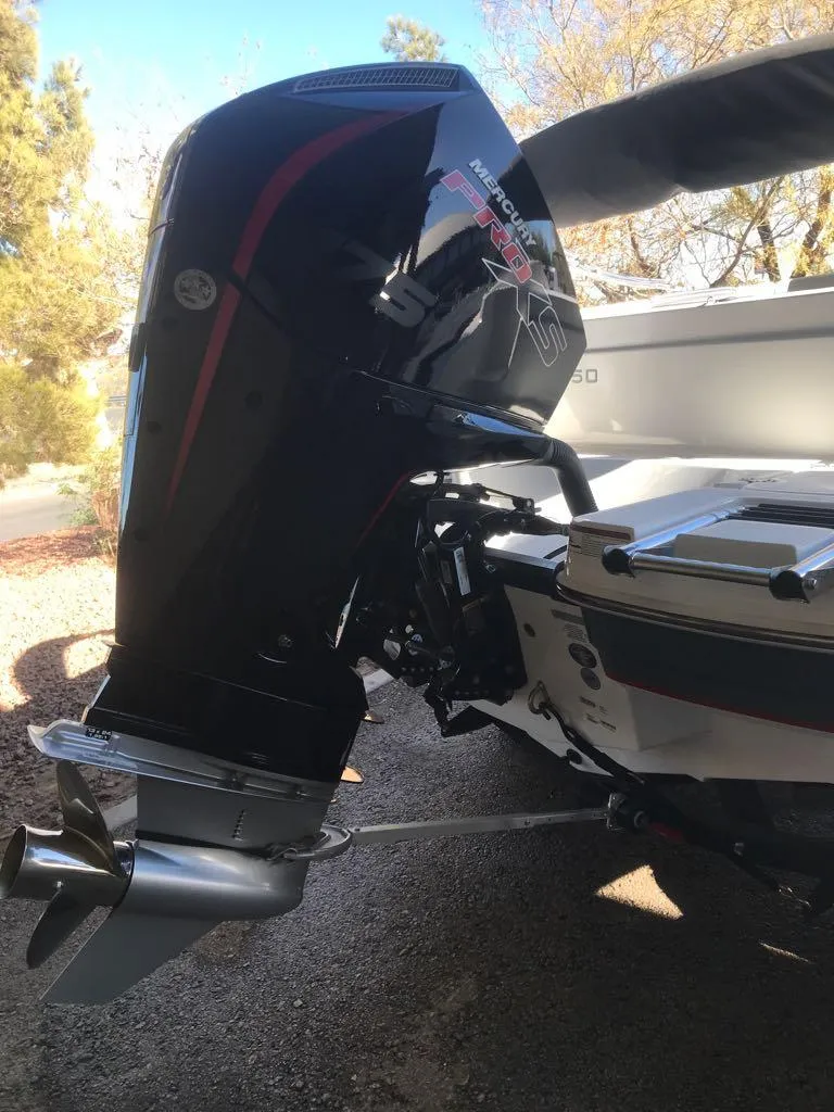 Slide: The Image of 2024 Tahoe 1950 boat with powerful outboard motor in a sunny outdoor setting. - 12