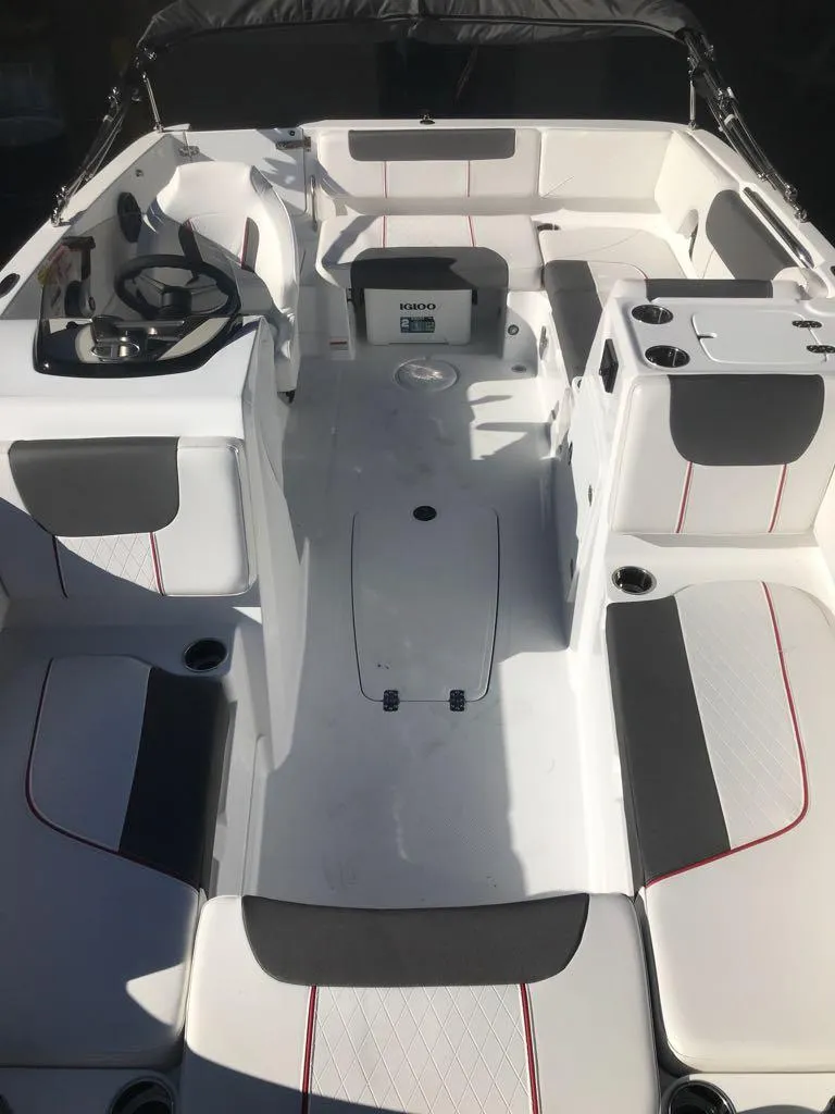 Slide: The Image of 2024 Tahoe 1950 boat interior with modern seating and steering console. - 13