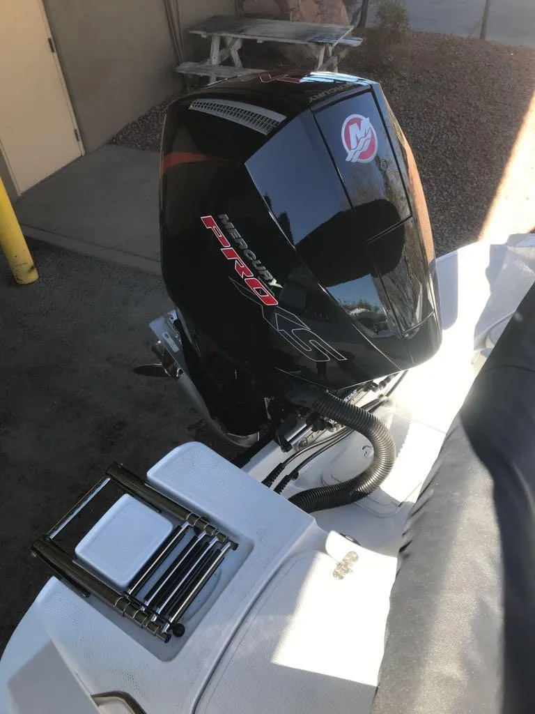 Slide: The Image of 2024 Tahoe 1950 boat with powerful outboard motor in a sunny setting. - 14