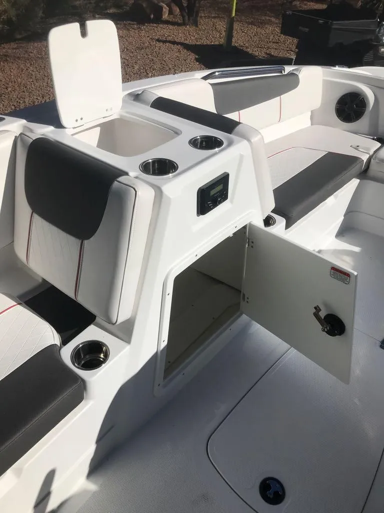 Slide: The Image of 2024 Tahoe 1950 boat interior with open storage compartments and cup holders. - 17