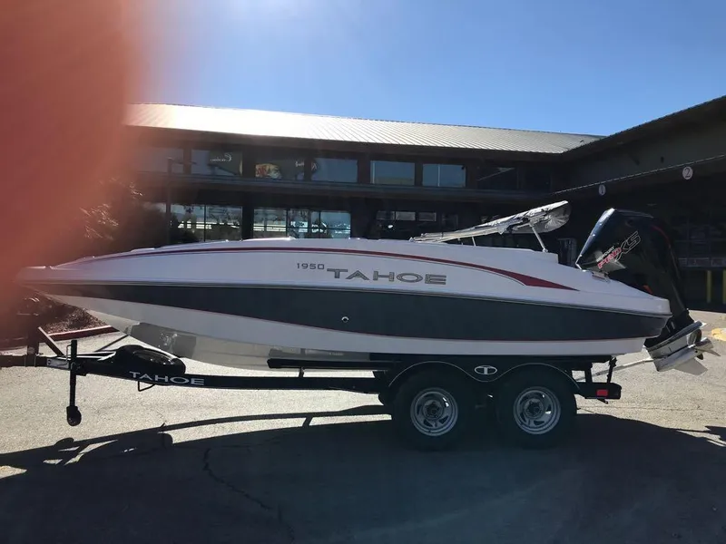 Slide: The Image of 2024 Tahoe 1950 boat on trailer, parked outdoors in sunlight. - 20