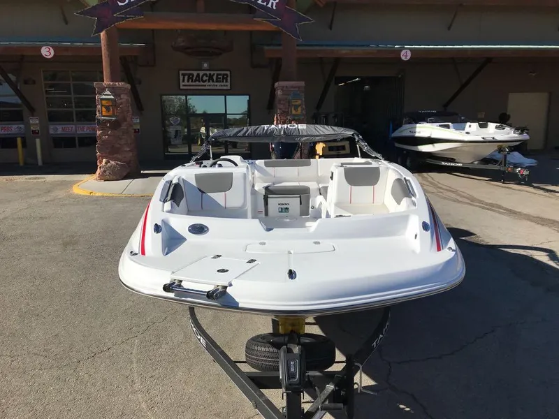Slide: The Image of 2024 Tahoe 1950 boat on trailer at dealership, front view. - 3
