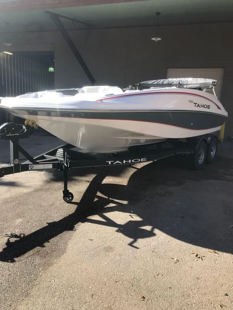 Slide: The Image of 2024 Tahoe 1950 boat on trailer in a garage setting. - 6