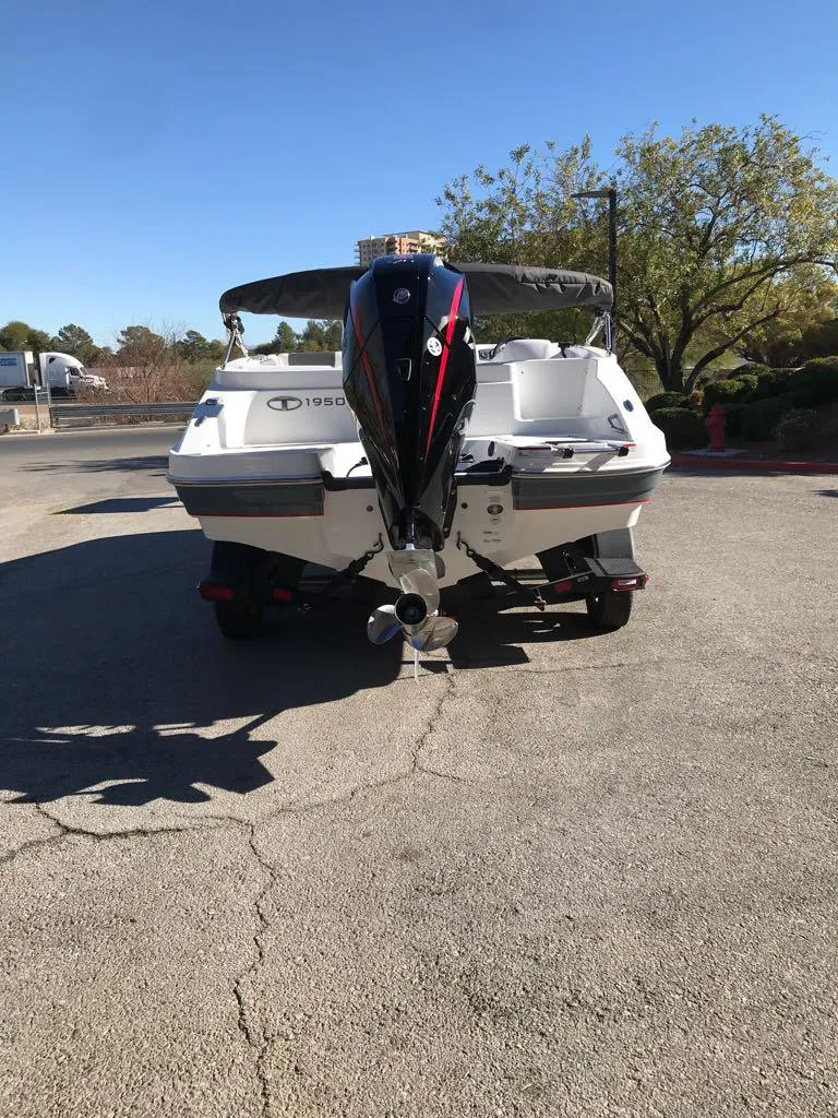 Slide: The Image of 2024 Tahoe 1950 boat, rear view, parked outdoors on sunny day. - 7
