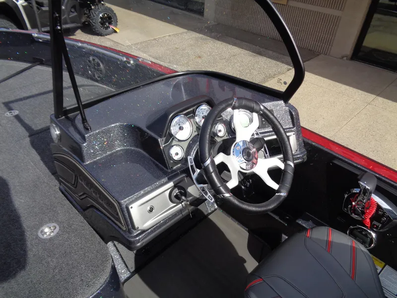 Slide: The Image of 2024 Nitro ZV21 boat cockpit with steering wheel and dashboard controls. - 11