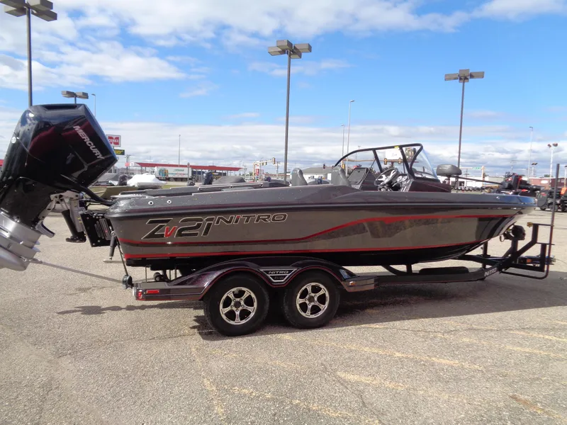 Slide: The Image of 2024 Nitro ZV21 boat on a trailer in a parking lot. - 4