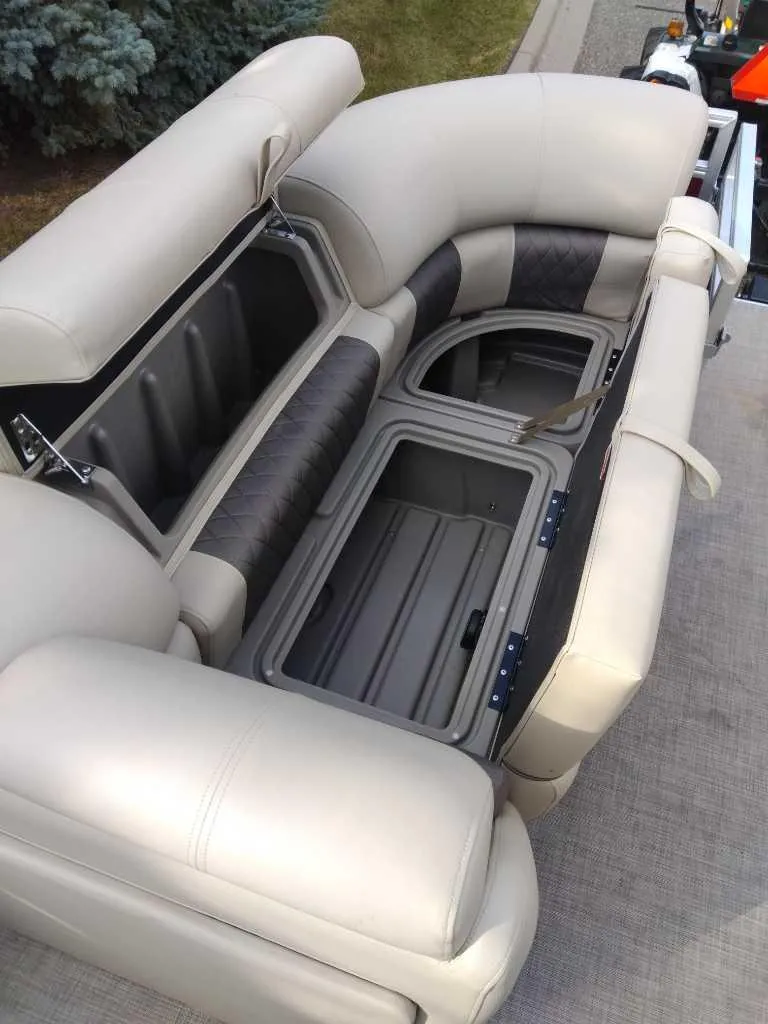 Slide: The Image of 2024 Sun Tracker Party Barge 20 DLX seating with open storage compartments. - 3