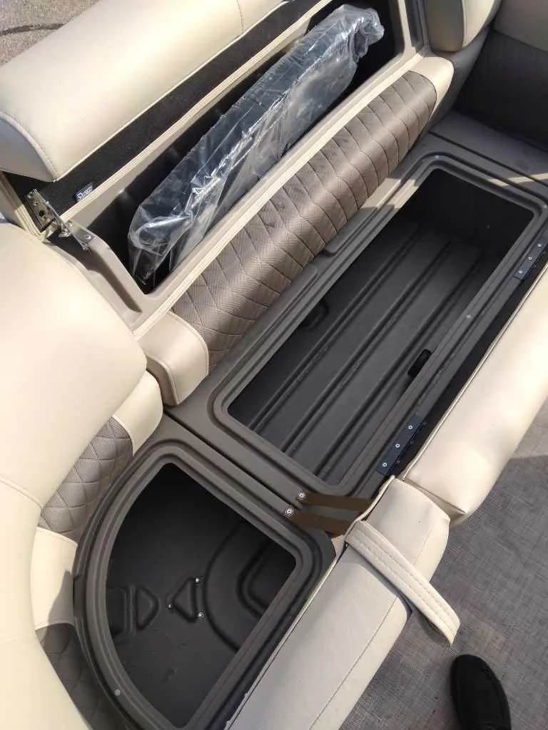 Slide: The Image of 2024 Sun Tracker Party Barge 20 DLX storage compartments with cushioned seating. - 4