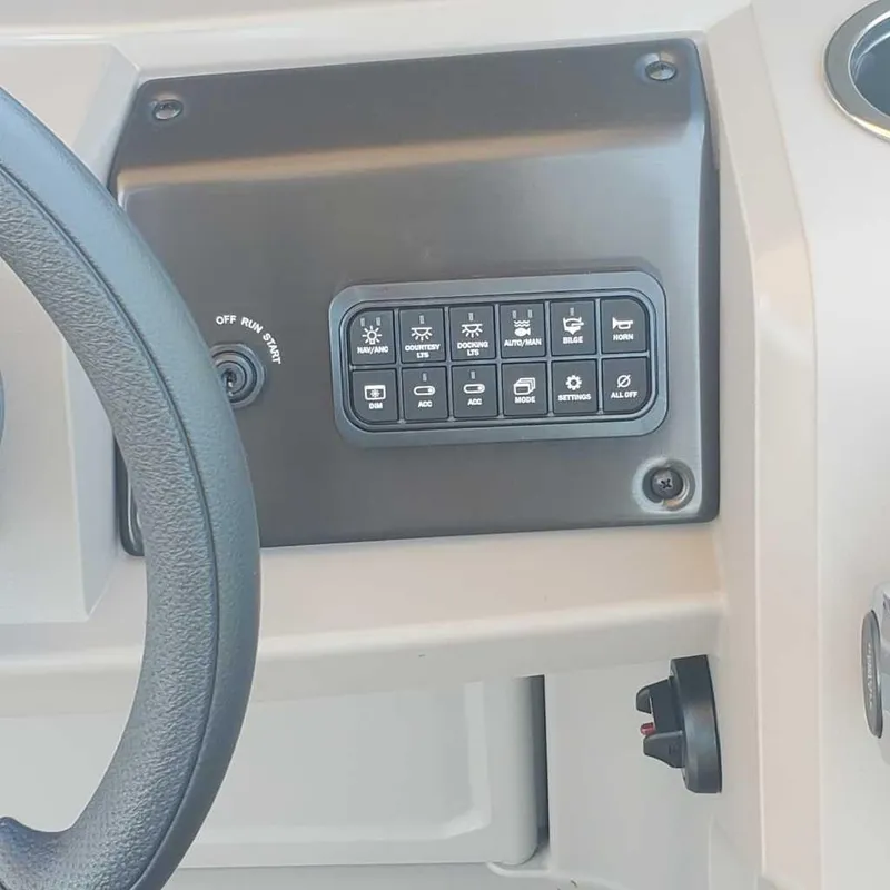 Slide: The Image of Control panel of 2024 Sun Tracker Sportfish 24 XP3 boat with steering wheel. - 10