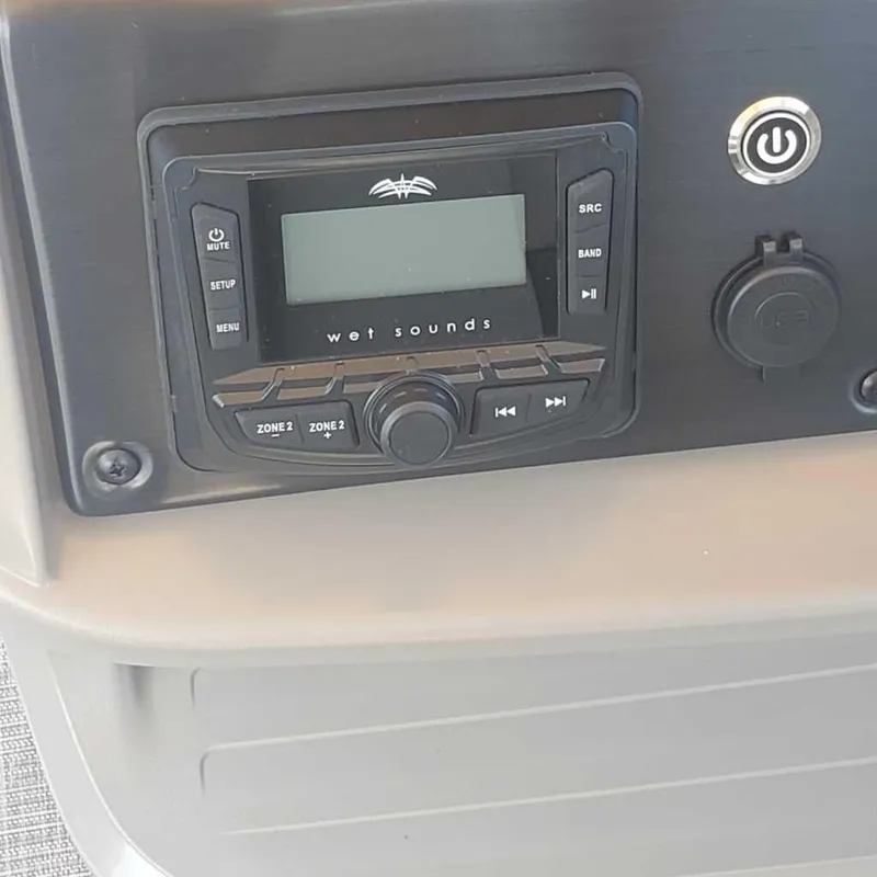 Slide: The Image of Control panel of the 2024 Sun Tracker Sportfish 24 XP3 with Wet Sounds audio system. - 11
