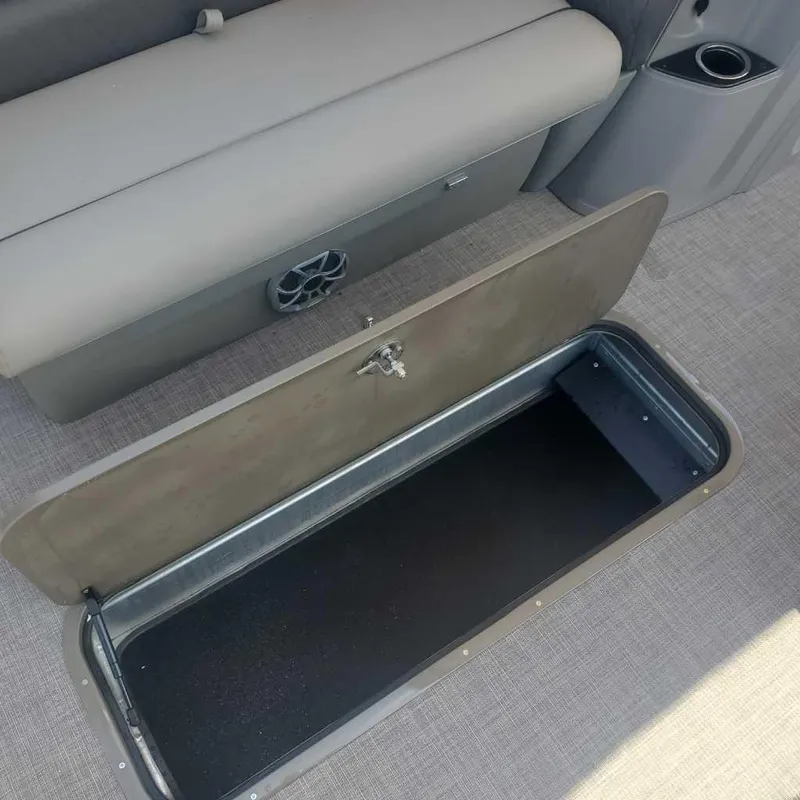 Slide: The Image of Open storage compartment on the 2024 Sun Tracker Sportfish 24 XP3 boat. - 12