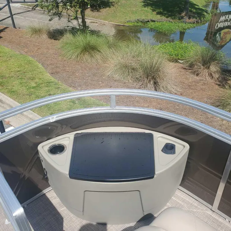 Slide: The Image of 2024 Sun Tracker Sportfish 24 XP3 boat console with cup holder and storage. - 13