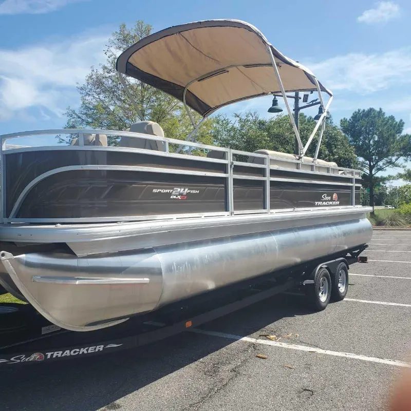 Slide: The Image of 2024 Sun Tracker Sportfish 24 XP3 pontoon boat on a trailer. - 3