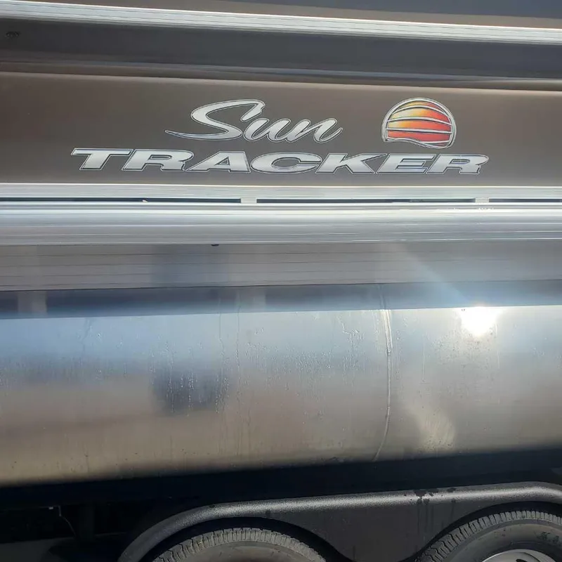 Slide: The Image of 2024 Sun Tracker Sportfish 24 XP3 pontoon boat side view with logo. - 5