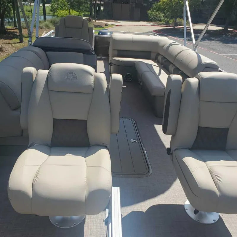 Slide: The Image of 2024 Sun Tracker Sportfish 24 XP3 pontoon boat with spacious seating and modern design. - 7