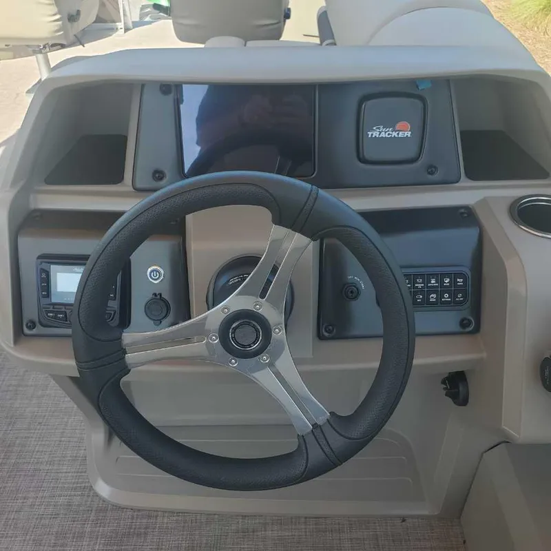 Slide: The Image of 2024 Sun Tracker Sportfish 24 XP3 boat steering console with controls and display. - 9