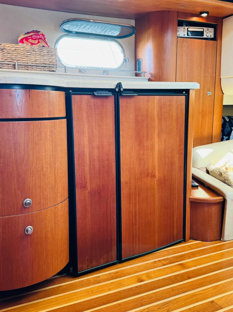 Slide: The Image of 2007 Tiara Yachts 3900 Sovran interior with wooden cabinetry and flooring. - 11