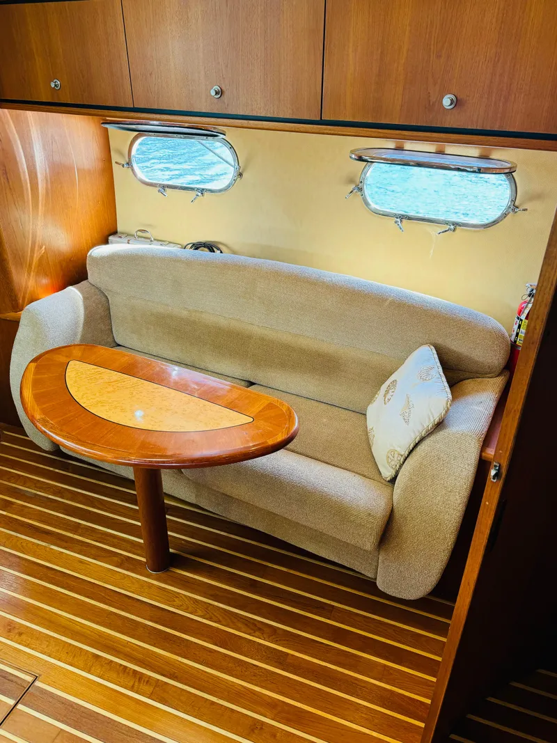 Slide: The Image of 2007 Tiara Yachts 3900 Sovran interior with sofa and wooden table. - 14